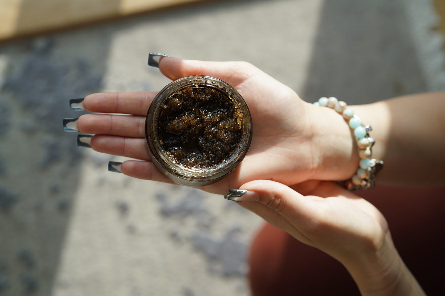Coffee Scrub on the hand of nestree model